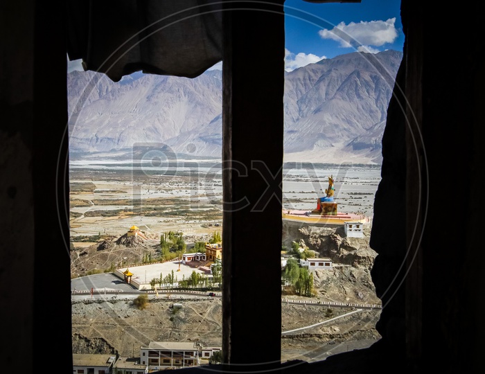 View of the Giant Maitreya Statue through a window