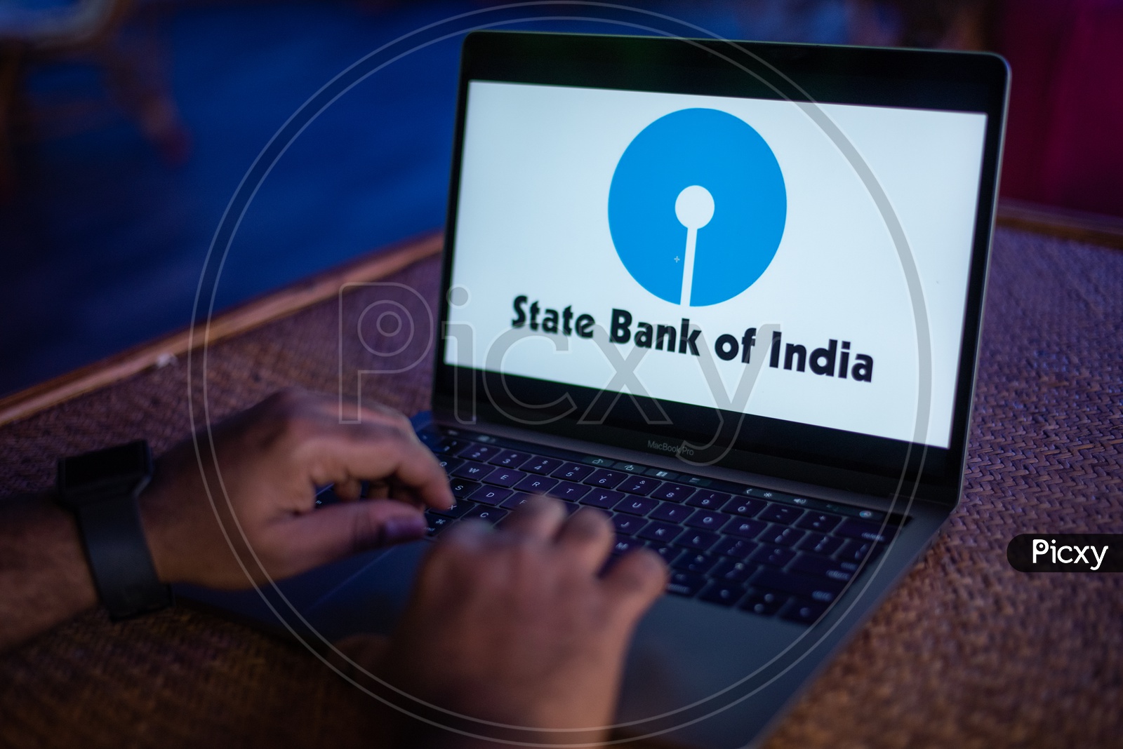 Indian Youth Accessing Online Banking Of State Bank Of India ( SBI ) in Laptop