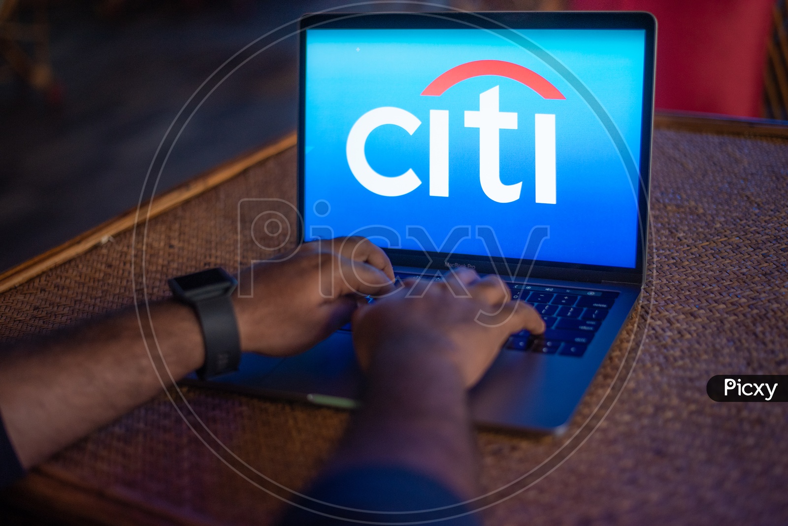 Indian Youth Accessing Online Banking Of Citi  BANK  in Laptop