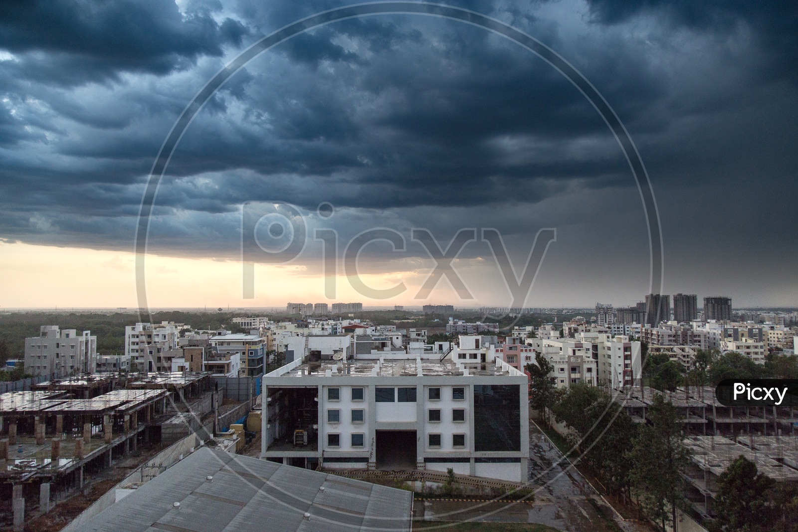 Hyderabad City Scape With High Rise Buildings With Thick Dark Clouds In Sky