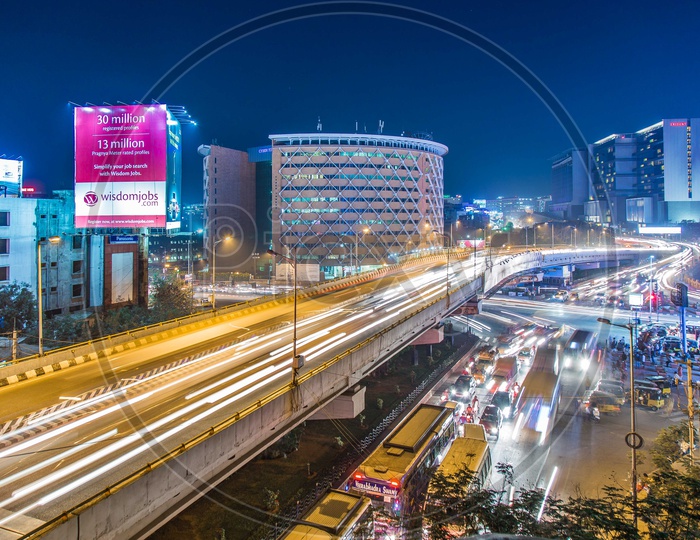 Long Exposure Shot Of Cyber Towers With Vehicles On Flyover