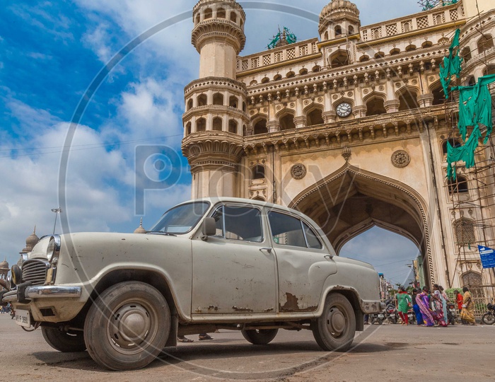 Old Ambassador on the road with Charminar in background