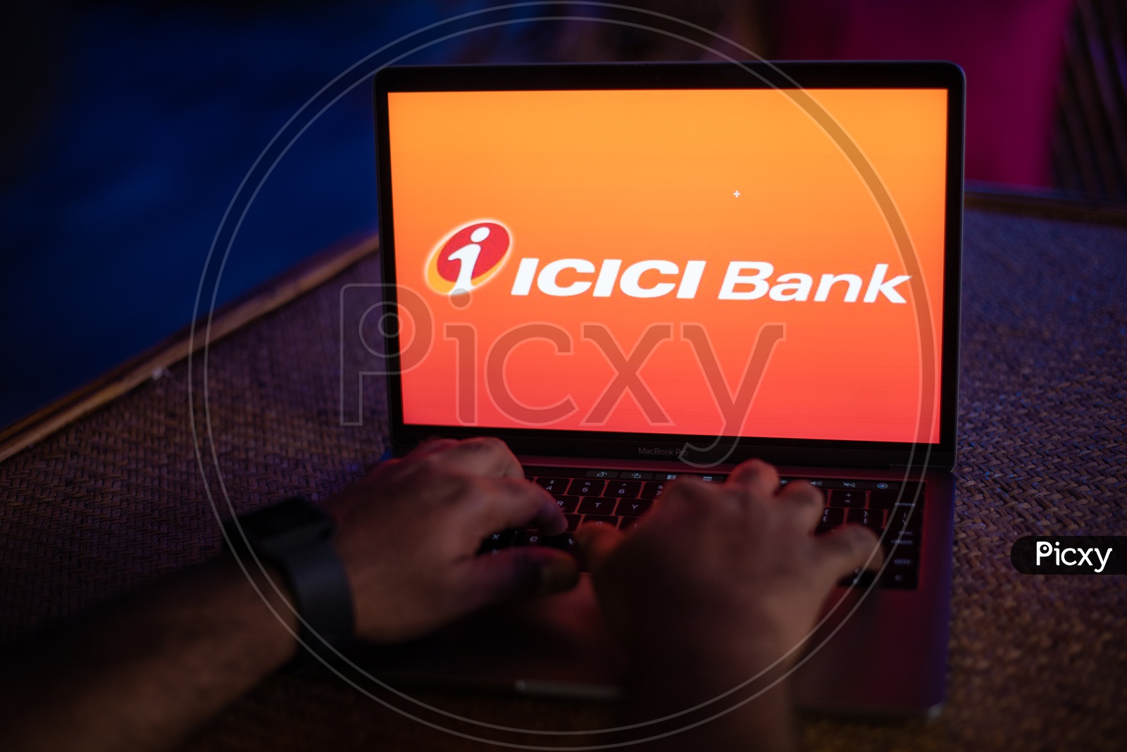 Indian Youth Accessing Online Banking Of ICICI  BANK  in Laptop
