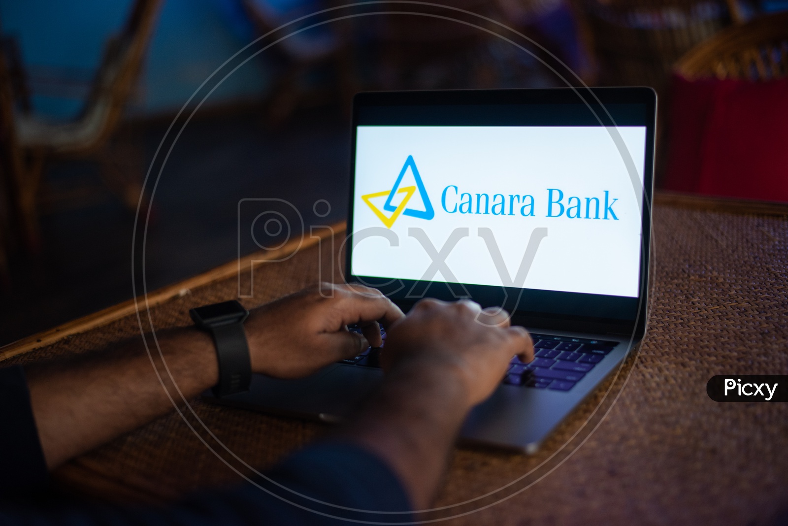 Indian Youth Accessing Online Banking Of Canara  BANK  in Laptop