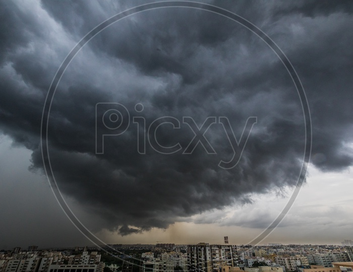 City Scape With High Rise Buildings On a Cloudy Day With Dark Black Clouds