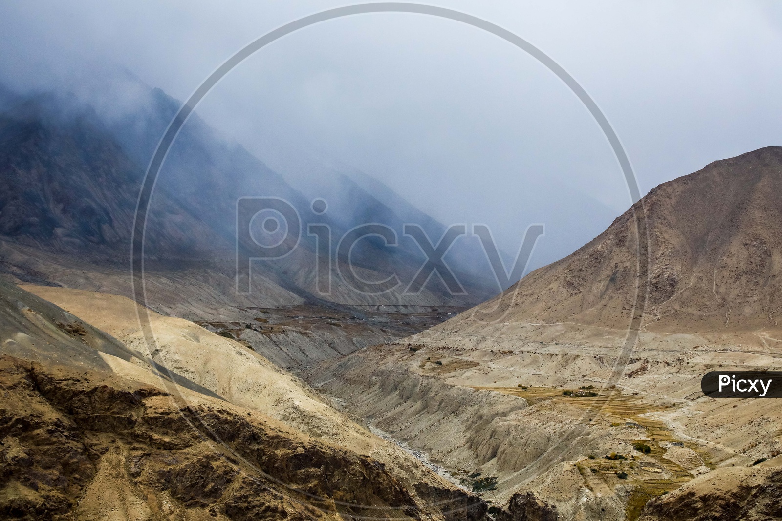 Zanskar river flowing through the misty mountains