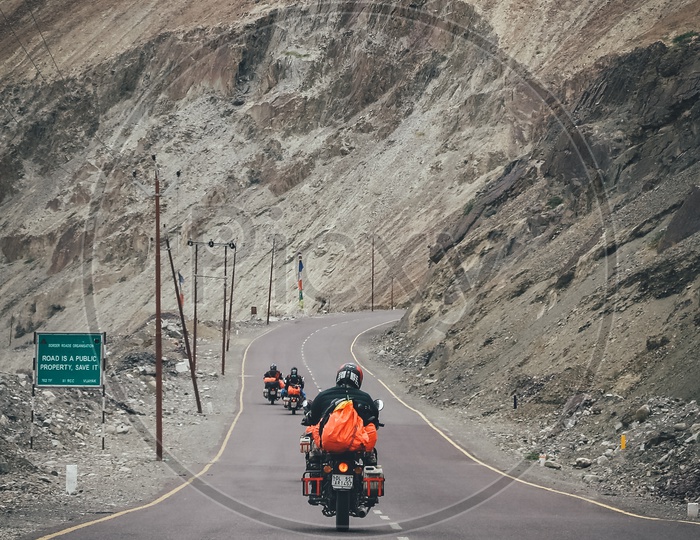 Group of travellers riding motorcycles on the highway through the hills