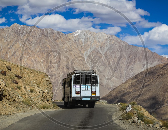 Moving bus on the roadway through the mountains
