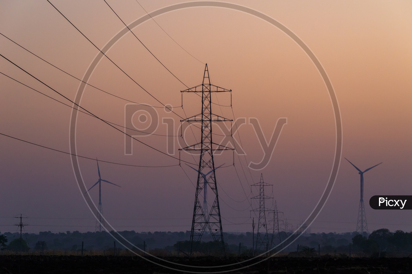 Windmills and Electric lines during Sunset