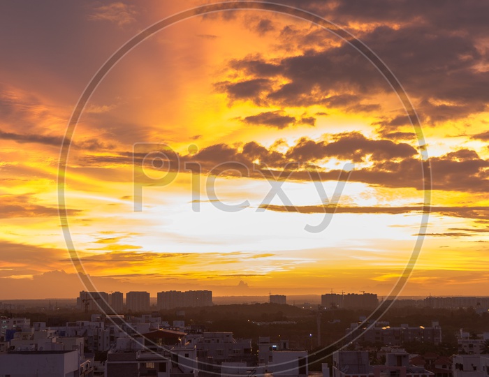 A city Scape view with a Golden Hour sky and Dark Clouds