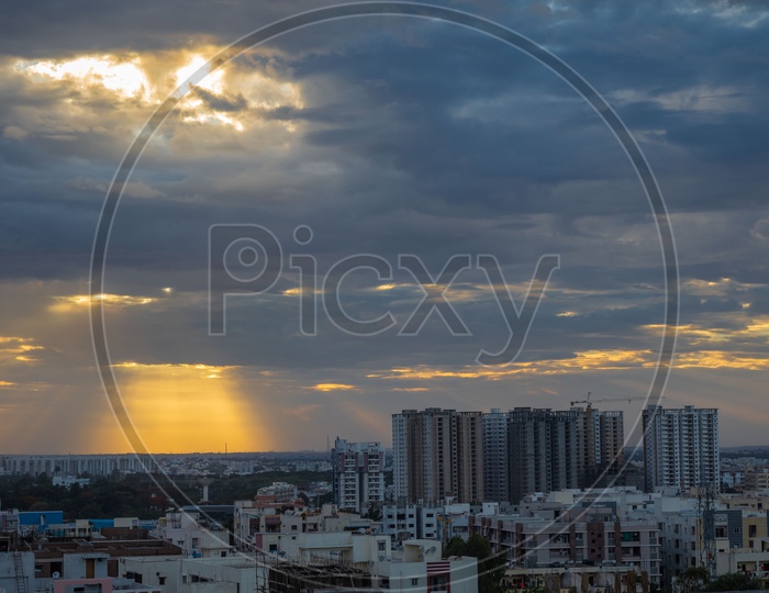 Hyderabad City scape With High Rise Buildings Over a Golden Hour Sky With Dark Clouds