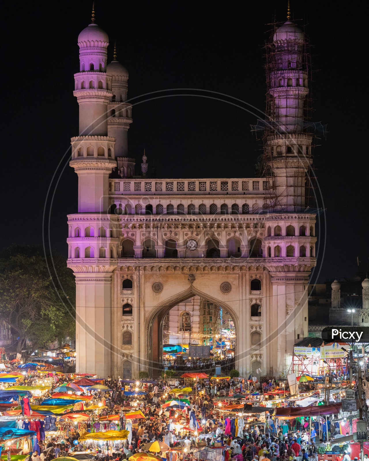 Street bazaar crowd during night with Charminar in the background