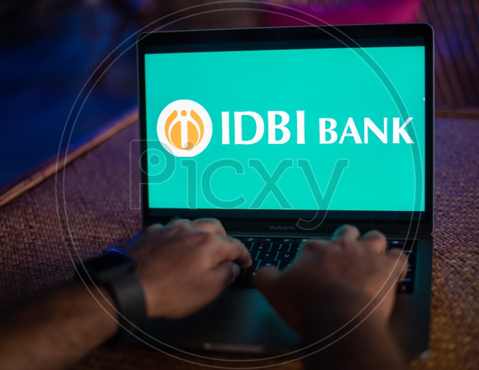Indian Man Accessing IDBI BANK Portal In Laptop