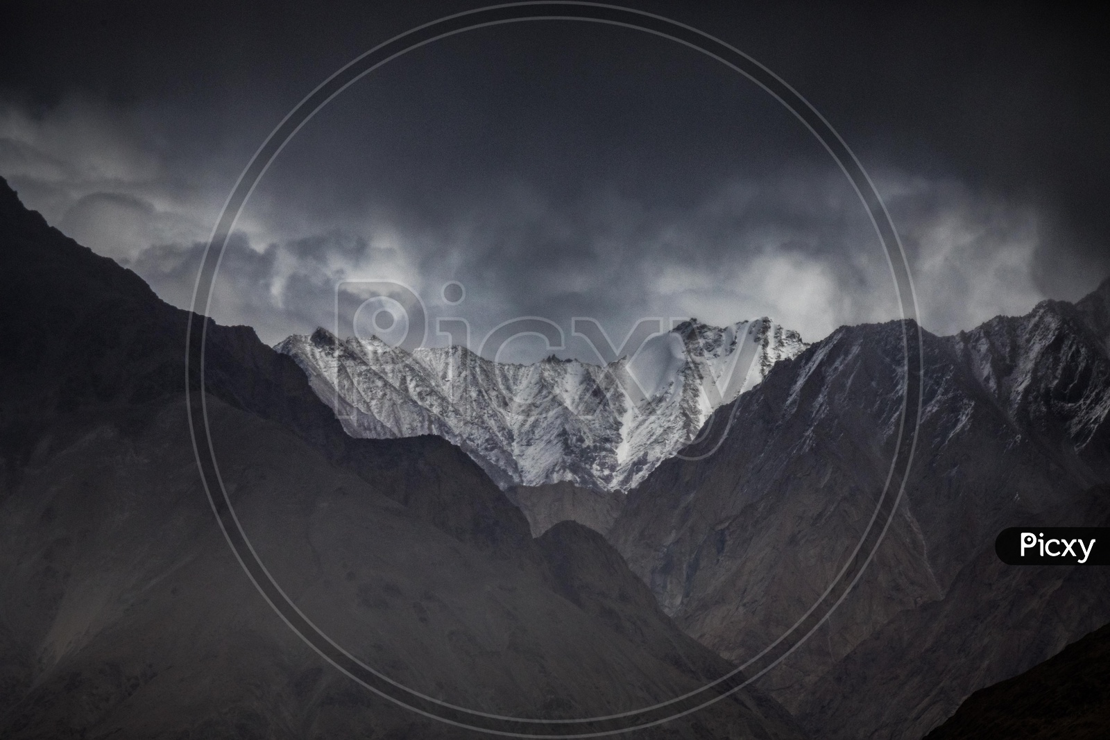 Dark clouds covered snow capped Himalayan Ranges
