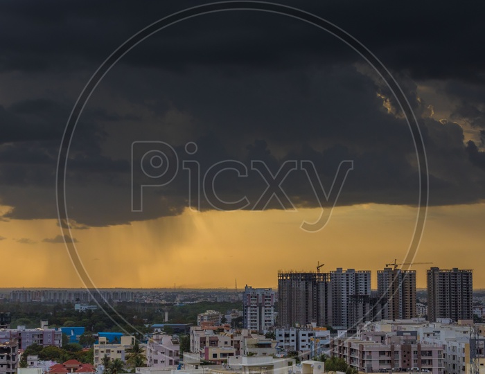 City Scape of Hyderabad With High Rise Buildings And Apartments On a Cloudy Day With Dark Clouds in background