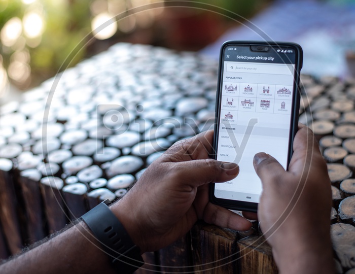 Indian Man Accessing Rapido App For Booking Bike Taxi In Smart Phone