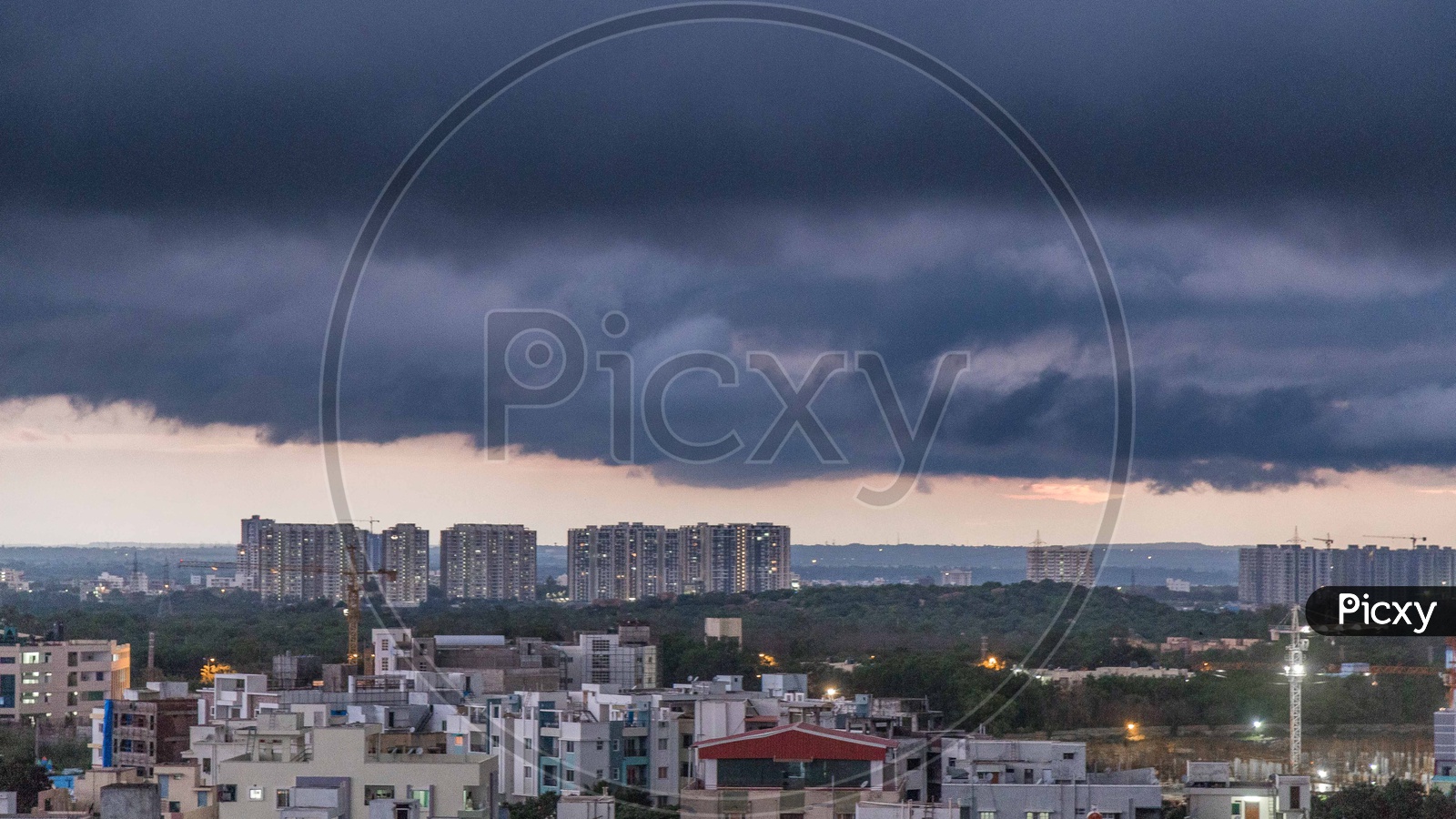 Hyderabad City Scape With High Rise Construction Buildings And Apartments over  Dark  Clouds Background