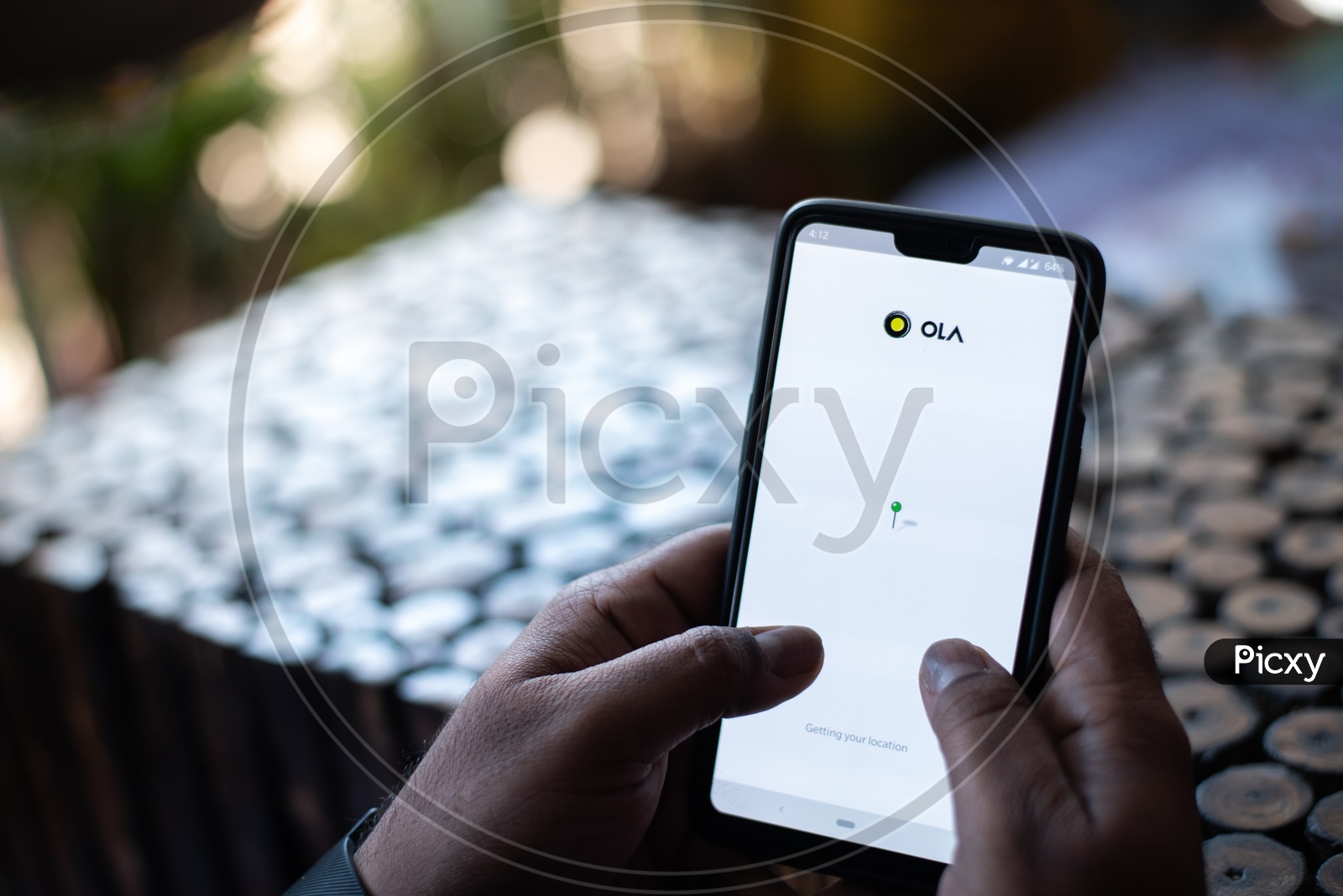 Indian Man Using OLA App for Car Taxi Booking in Smart Phone