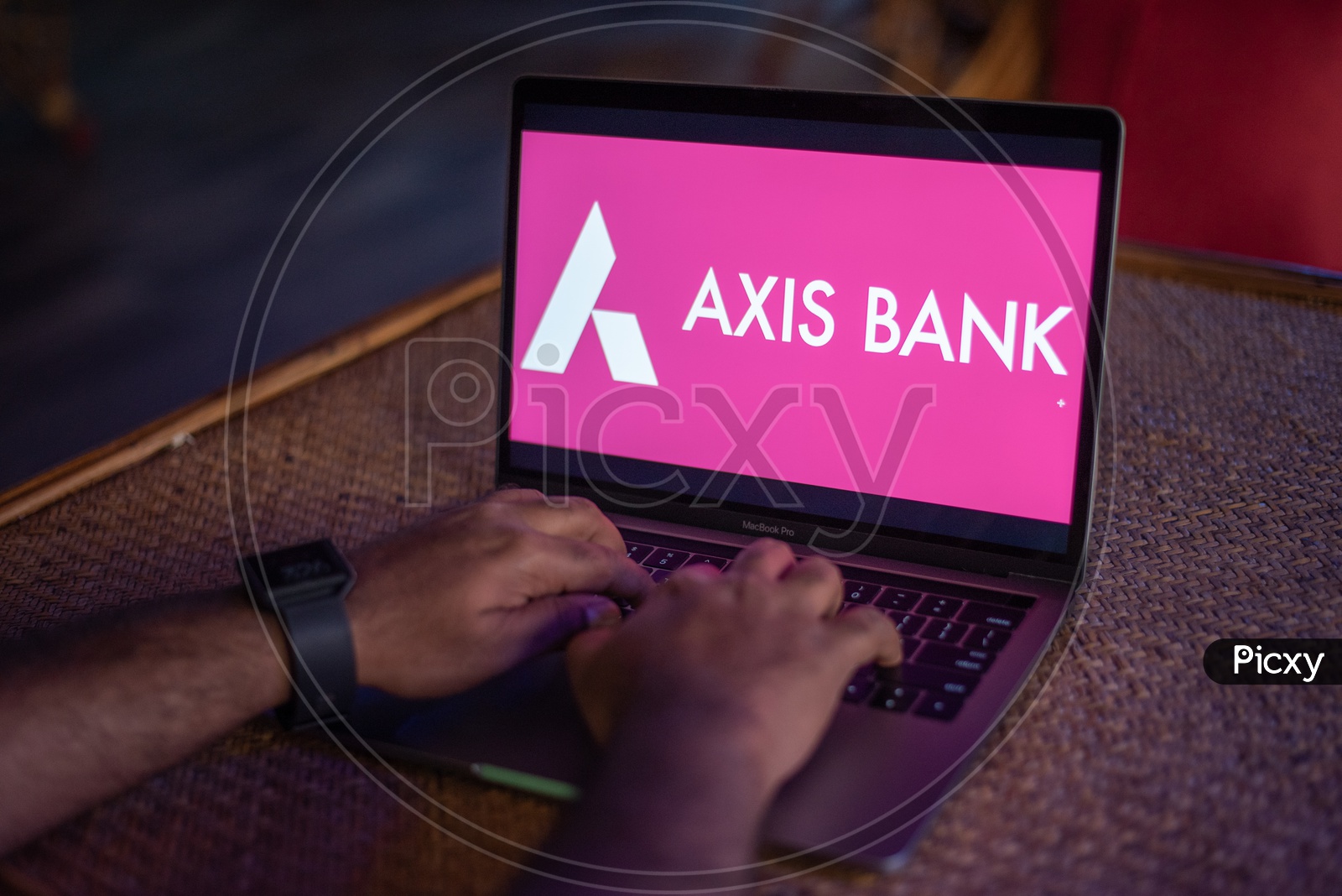 Indian Youth Accessing Online Banking Of  AXIS BANK  in Laptop