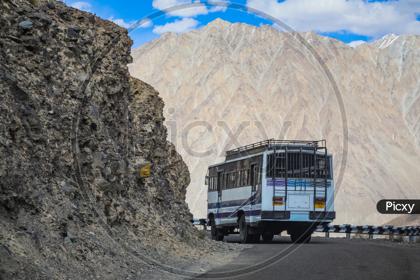 Moving bus on the roadway by the mountains