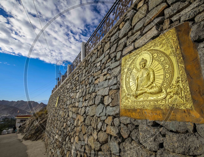 Lord Buddha engravement on the rock wall