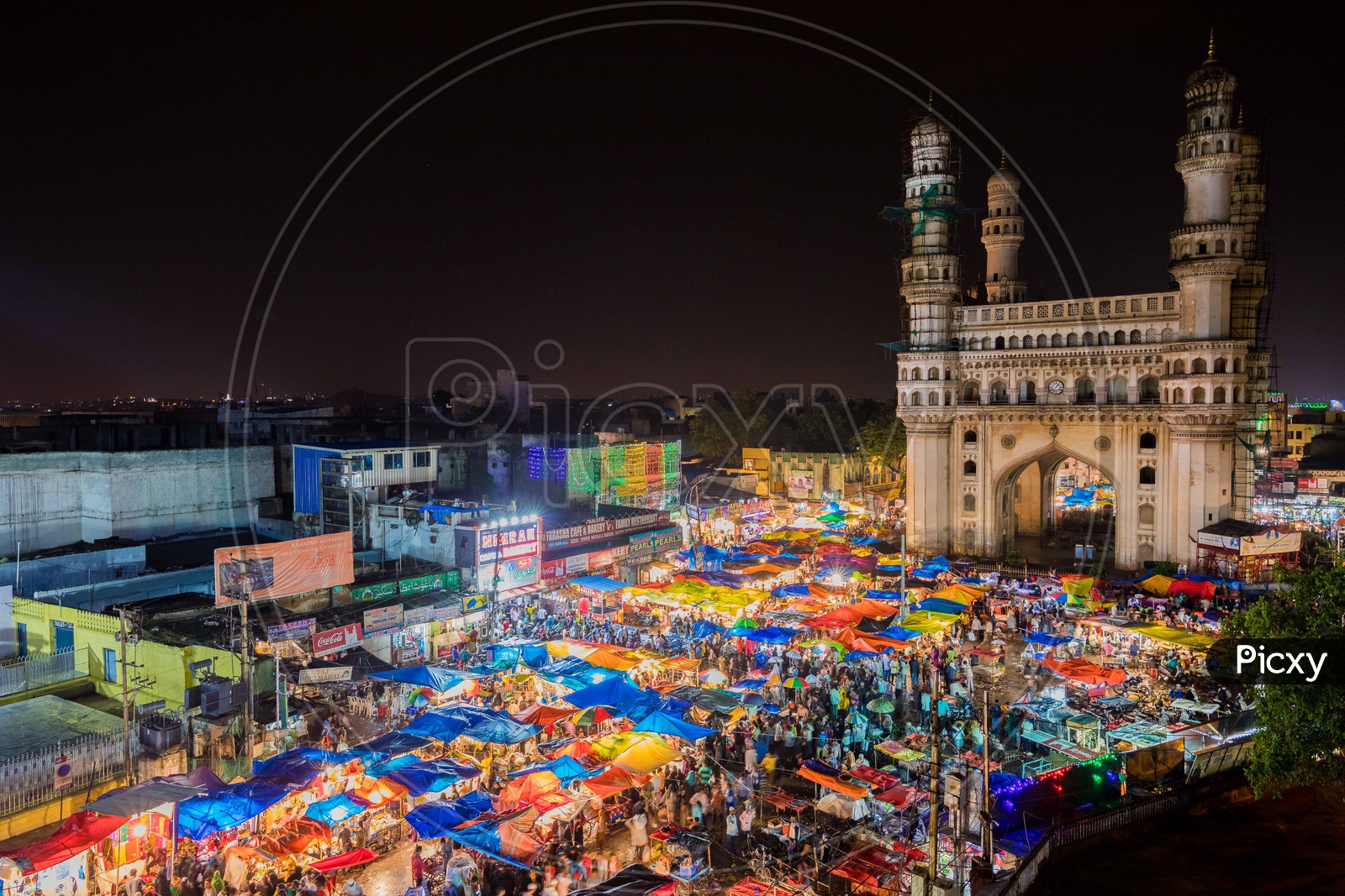 View of Crowd during the night in street bazaar with charminar in background
