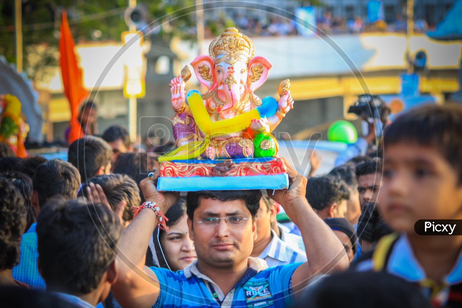 Man Carrying Lord Ganesh or Ganapathi on head