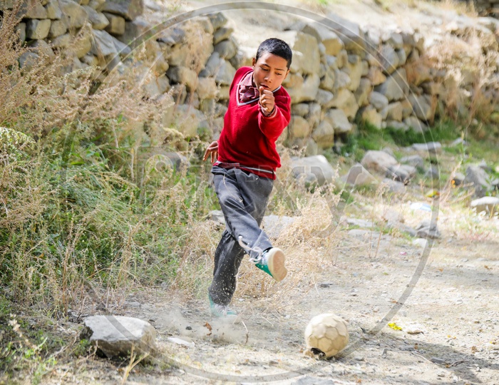 A Himalayan kid playing football