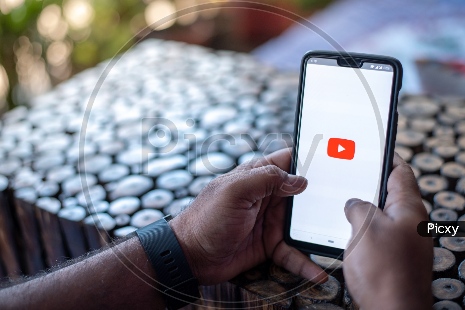 Indian Man browsing videos on YouTube app in Smart Phone