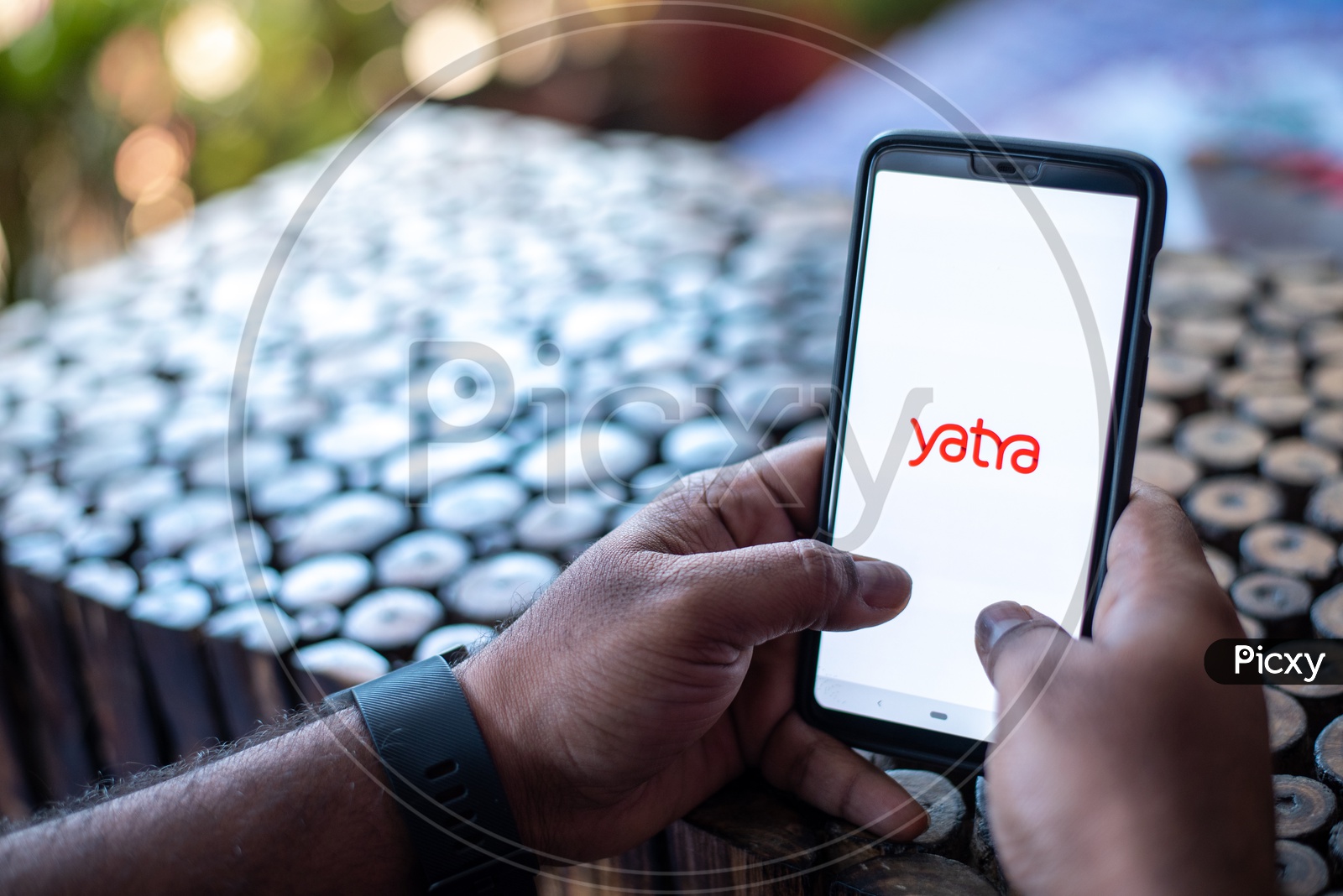 Indian Man using Yatra App  in Smart Phone