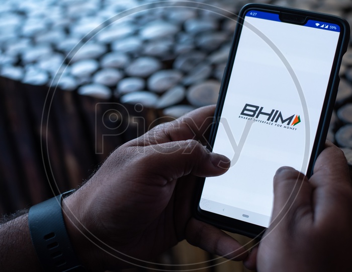 Indian Man Using BHIM UPI App in Smart Phone