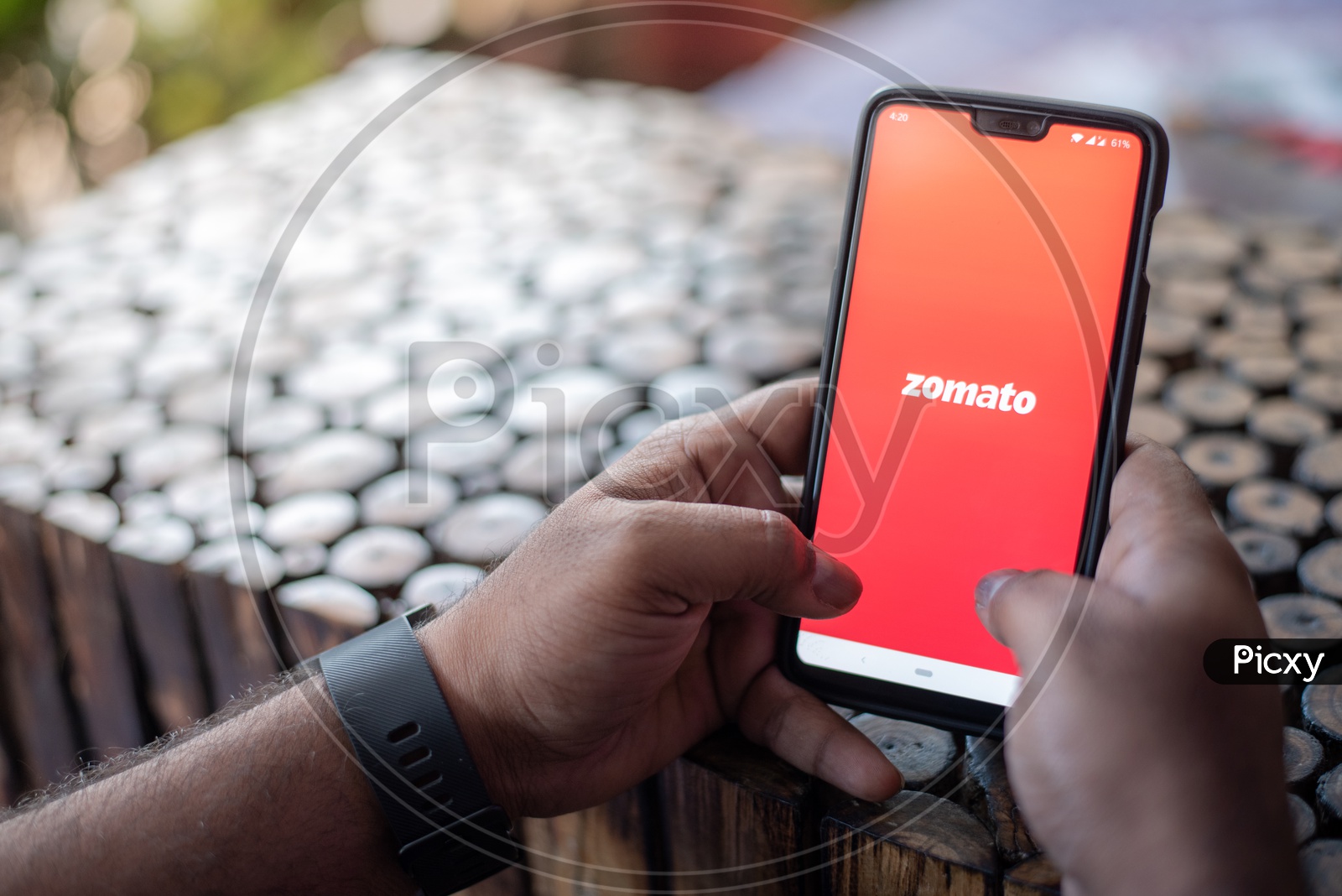 Indian Man using Zomato App for online food delivery in Smart Phone