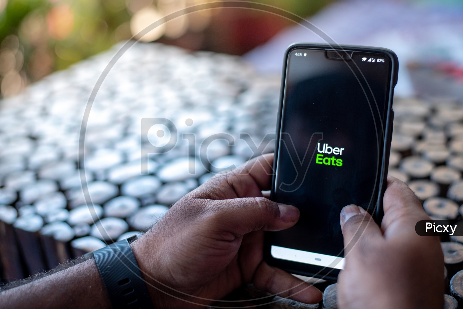 Indian Man using Uber Eats app  in Smart Phone