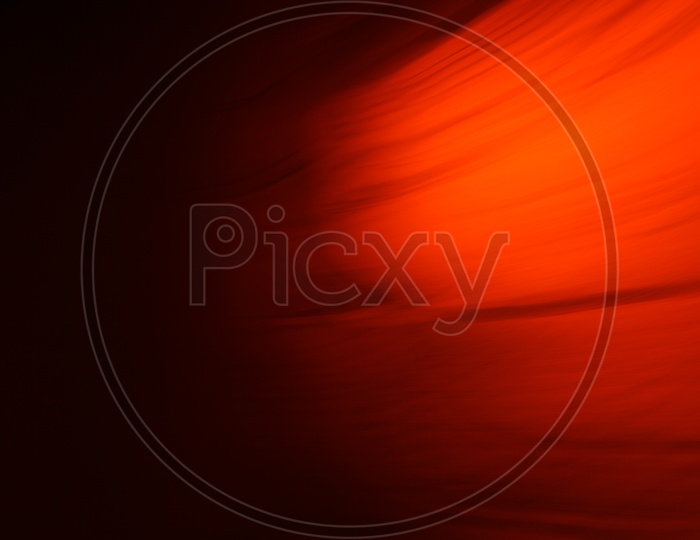 Abstract of blurred orange light trail pattern with black background
