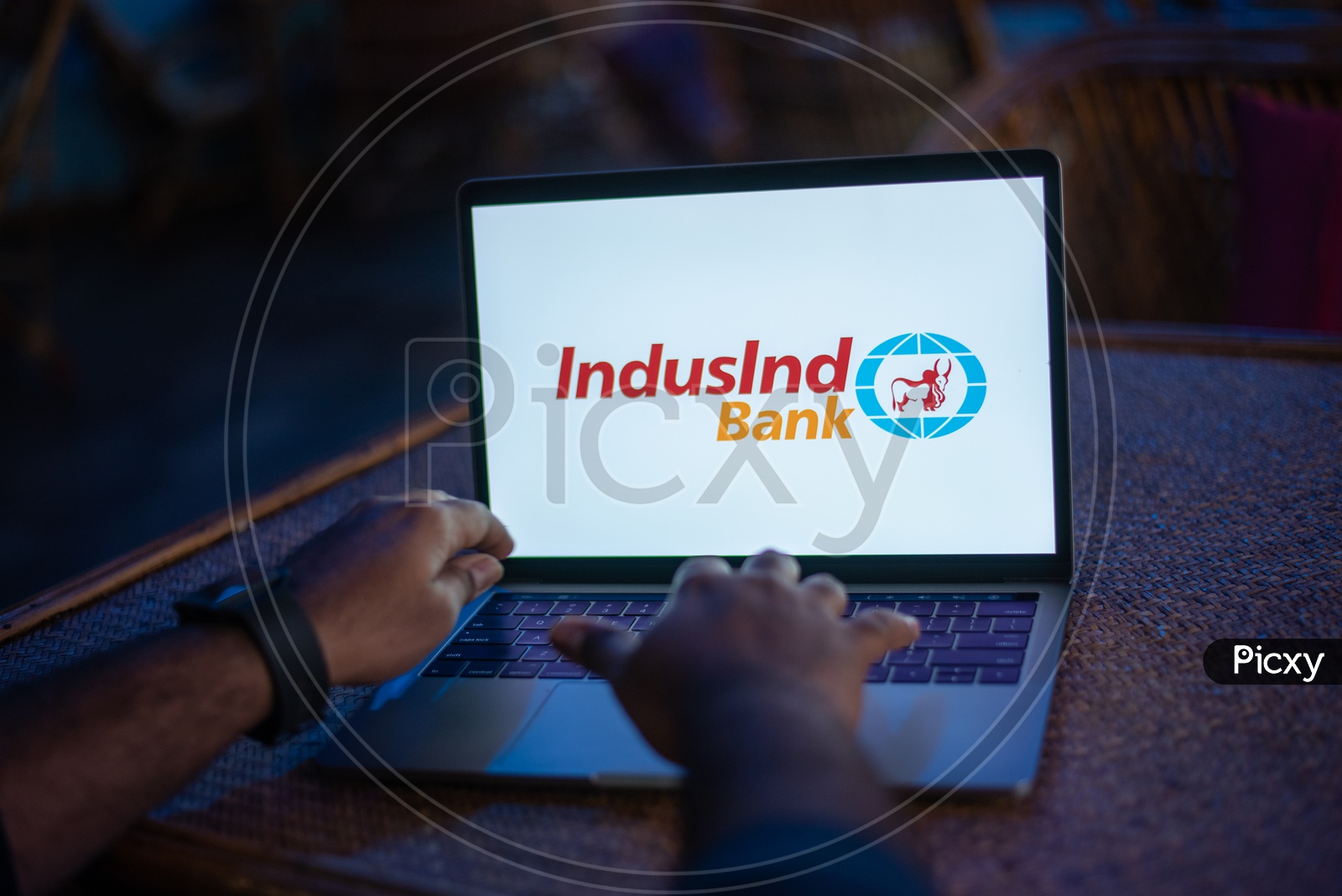 Indian Youth Accessing Online Banking Of IndusInd  BANK  in Laptop