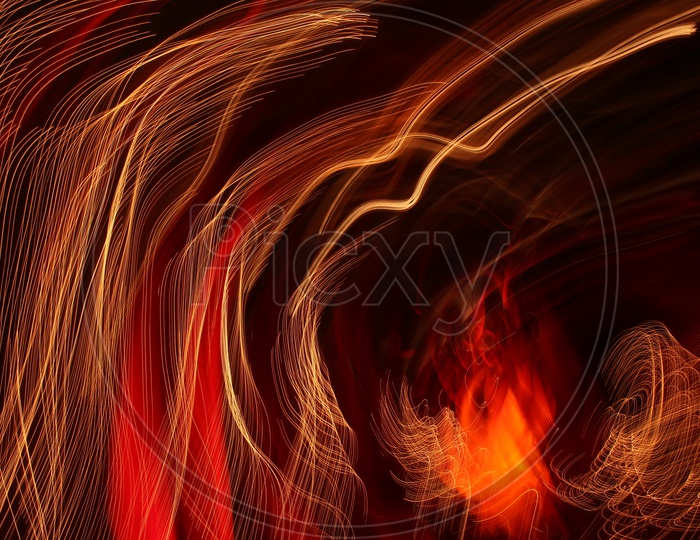 Abstract of blurred light trail pattern in red and gold with black background