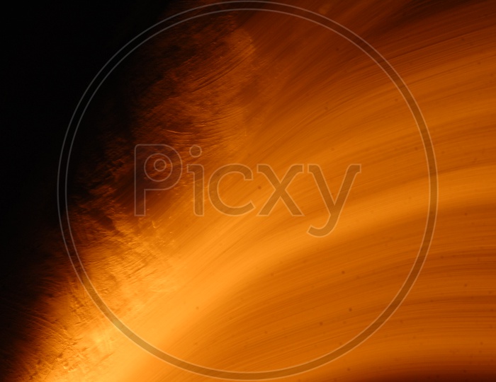 Abstract of blurred gold light trail pattern with black background