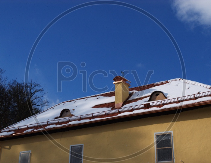 Snow capped roof top of a house