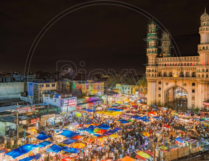 Crowd of street bazaar during the night  alongside the Charminar