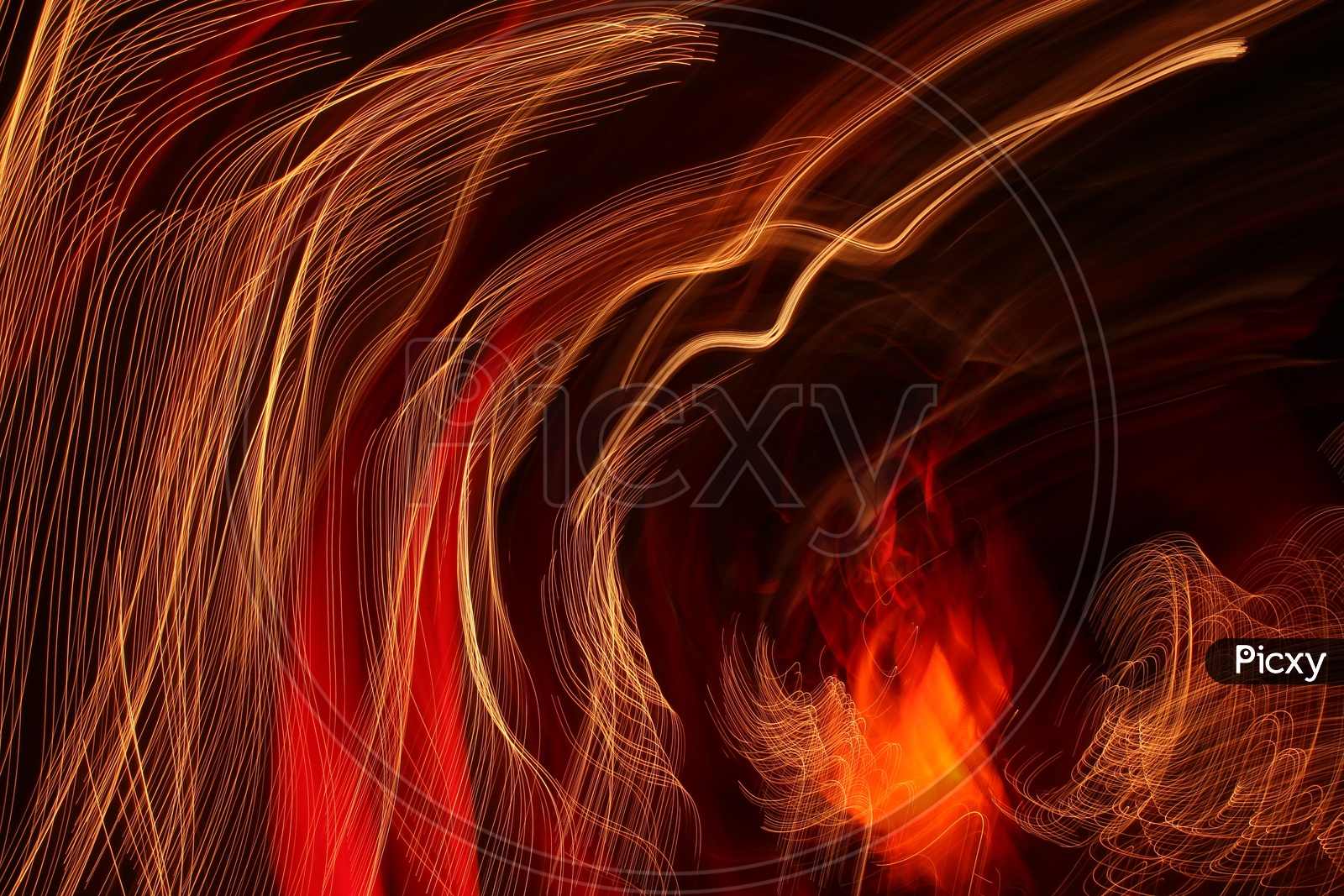 Abstract of blurred light trail pattern in red and gold with black background