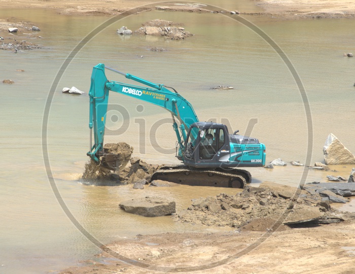 Bulldozer excavating the rocky layers in the mud