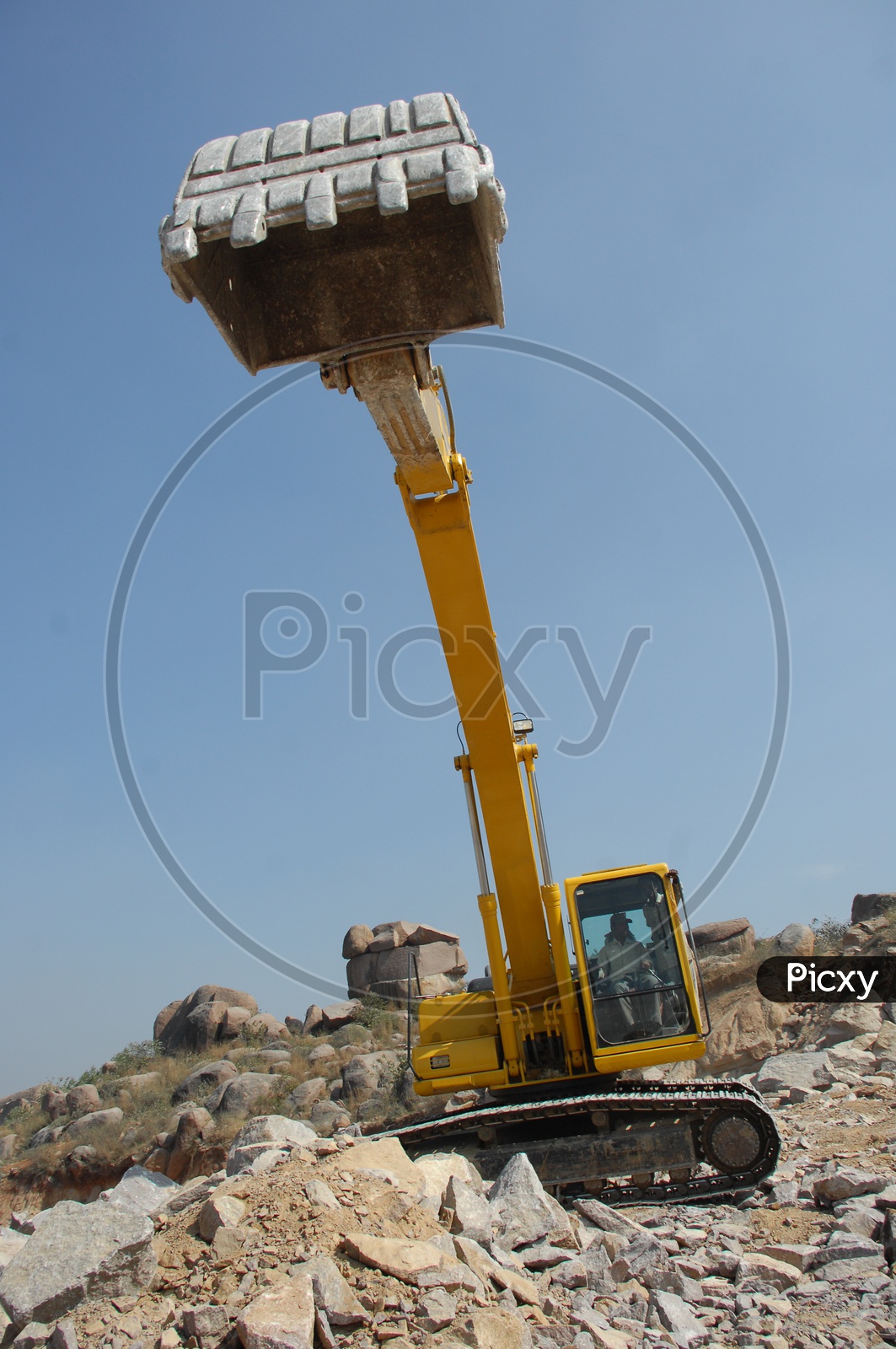 Bucket of the bulldozer excavating the rocks at a construction site