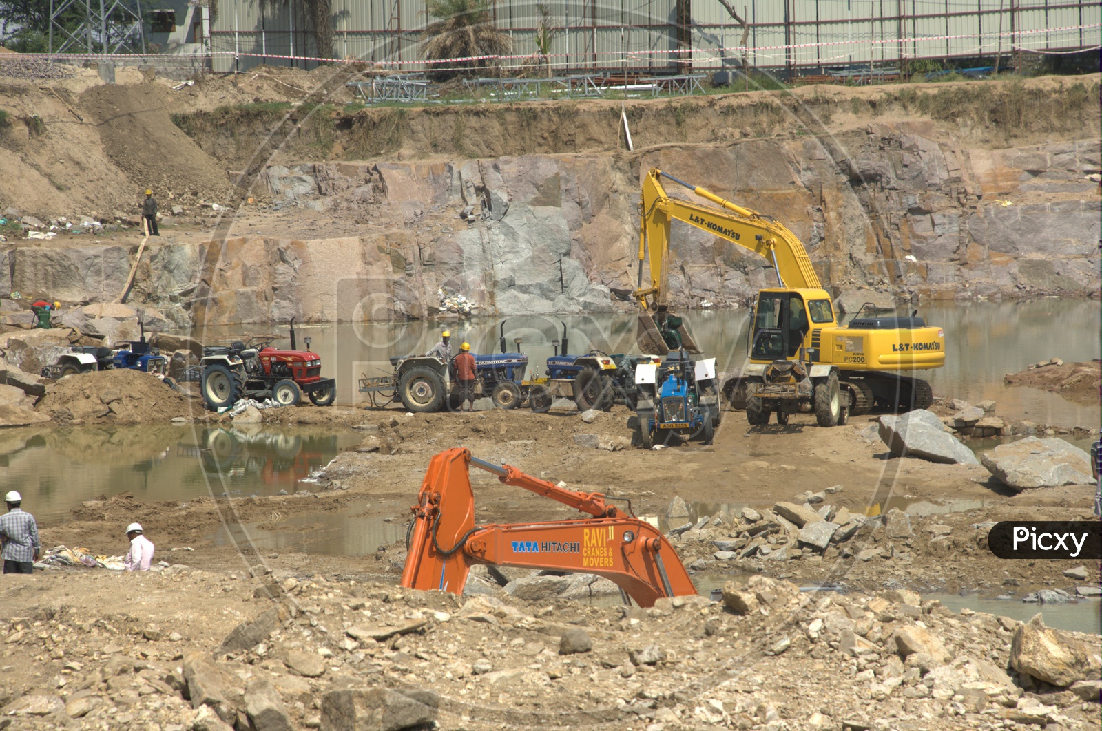Bulldozers and tractors alongside the excavation site