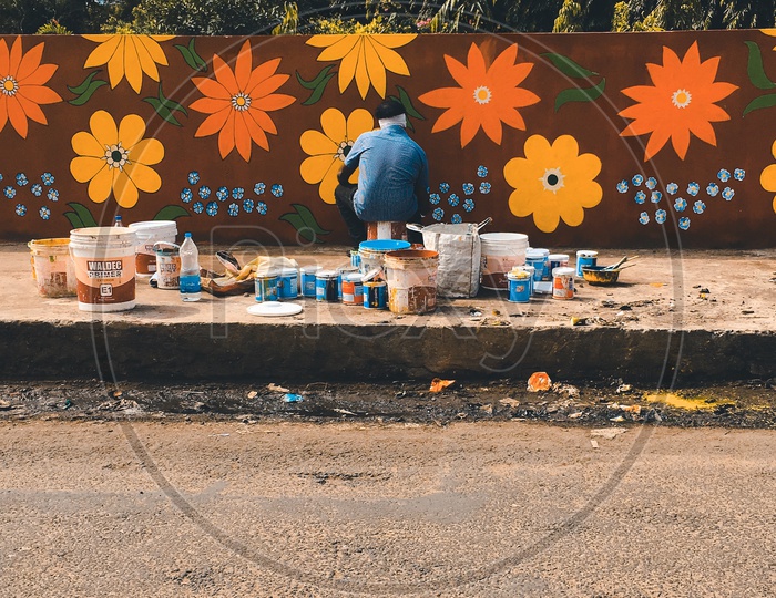 Painter painting the walls of a park
