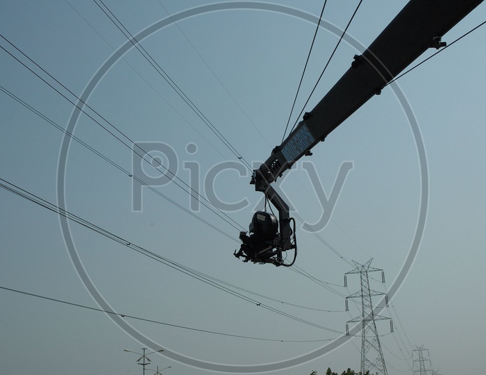 Camera Crane jib with electric tower in background