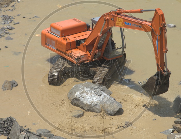 Bulldozer working at an excavation site in the water