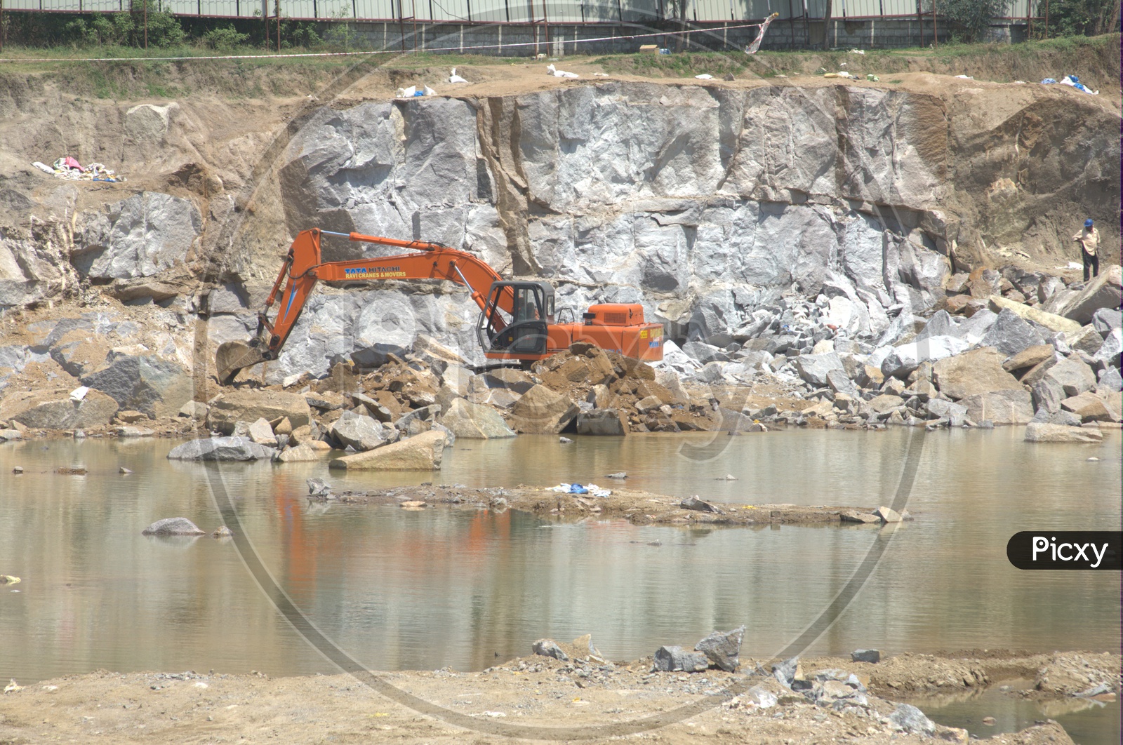 Bulldozer excavating the massive rock bodies