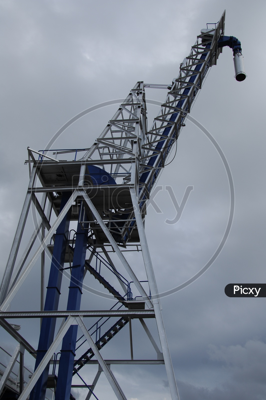 Crane equipment with cloudy sky in background