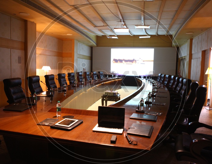 Round table conference room alongside the projector display