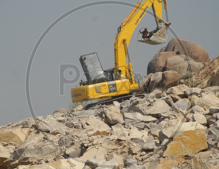 Man in the bulldozer bucket at a construction site